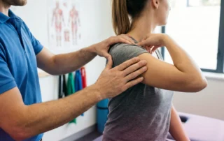 A healthcare professional demonstrates proper posture techniques to a patient in a modern clinic.