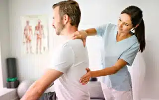 Physical therapist guiding patient through posture correction exercises to improve balance flexibility and spinal alignment
