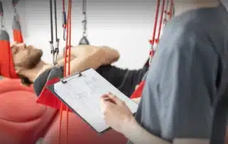 Patient receiving Redcord Neurac treatment in Santa Monica clinic